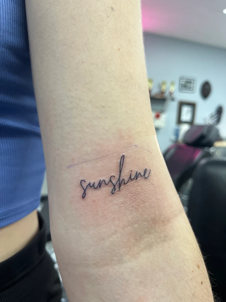 Fine line script tattoo on a wrist from the Secret Ink portfolio in Naples